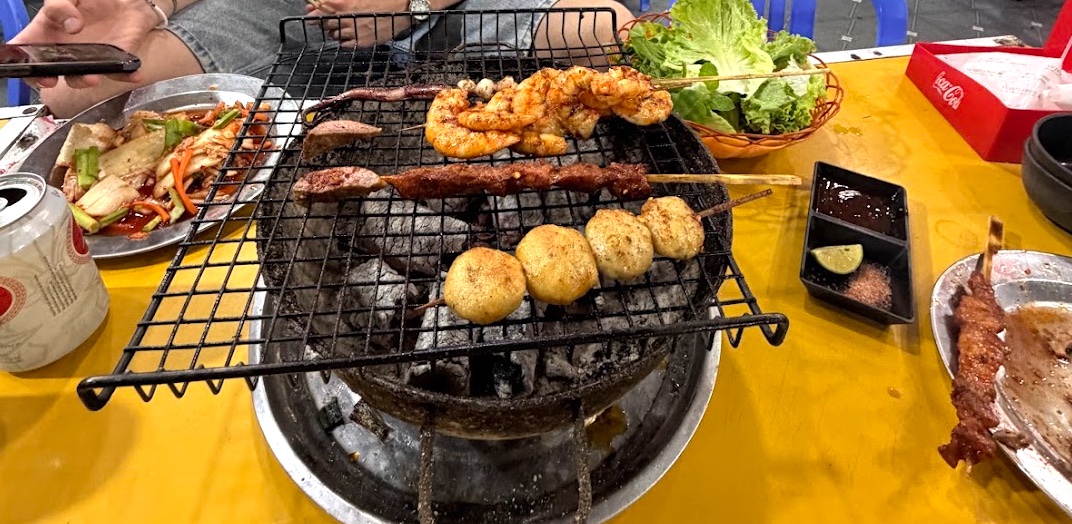 Barbecue-Abend mit George in Sapa — Grillspieße mit Garnelen, Fleisch und Wachteleiern auf dem Tischgrill
